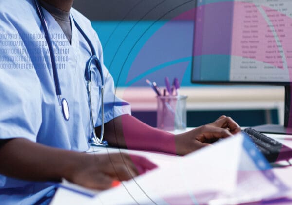Doctor putting healthcare data into a computer